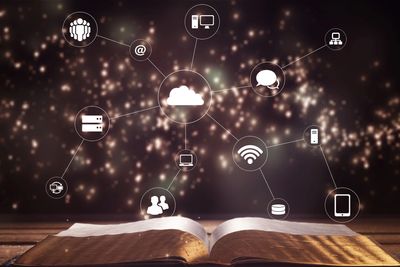 Open book with digital cloud and technology icons connecting knowledge and connectivity.