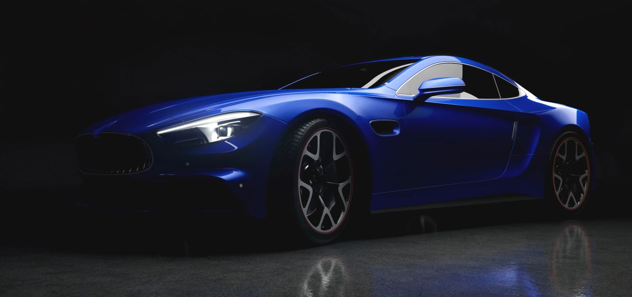 A side-profile shot of a modern blue sports car angled forward in a dimly lit studio.