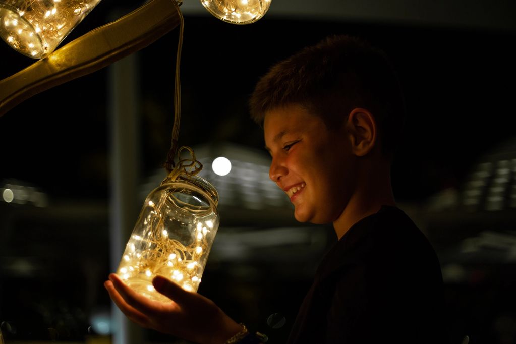 Boy with fireflies in a mason jar