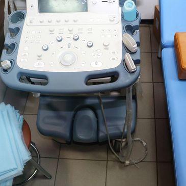 Medical ultrasound machine in examination room.