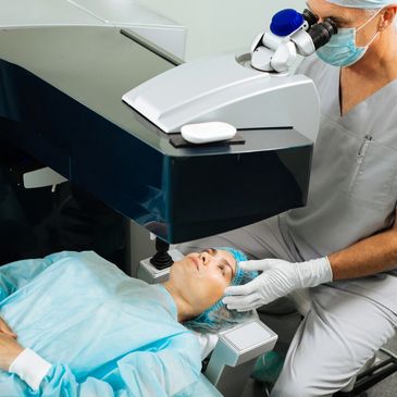 Patient undergoing laser eye surgery with a doctor operating advanced equipment.