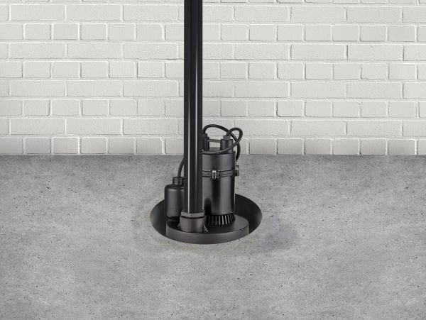 Black sump pump installed in basement floor.