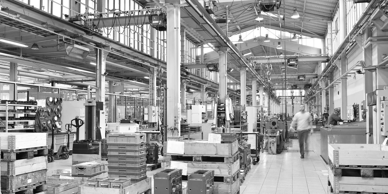 Busy industrial factory with machinery and workers.