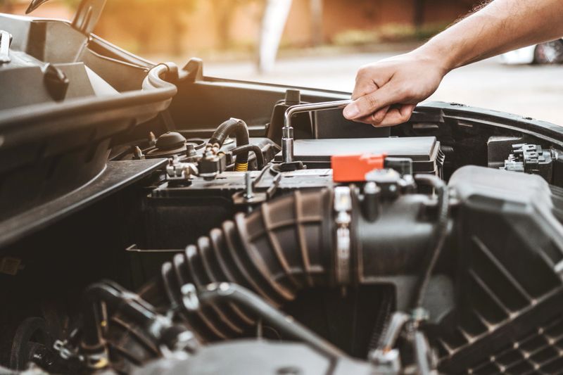 Auto mechanic working in garage Technician Hands of car mechanic working in auto repair Service and Maintenance car check.