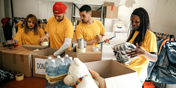 Volunteers packing donation boxes in a community center.