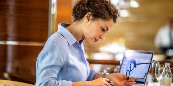 Woman working with glasses and laptop.