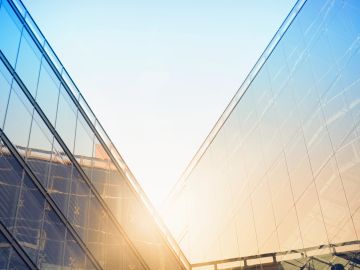 Sunlight reflecting off glass skyscrapers at sunrise.