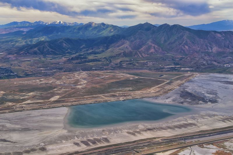 Great Salt Lake Utah Aerial view from airplane looking toward Oquirrh Mountains and Antelope Island, Tooele, Magna, with sweeping cloudscape. United States.