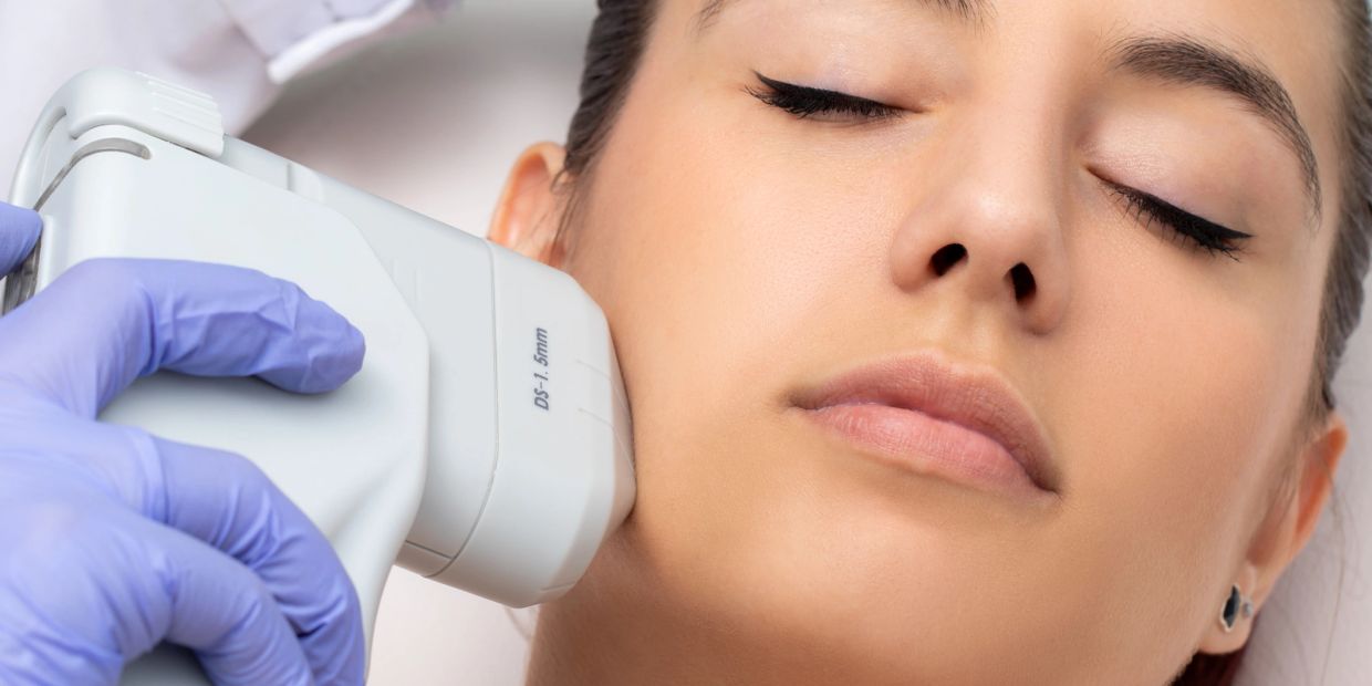 Woman receiving a laser skin treatment on her face.