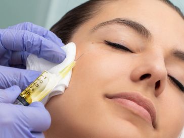 Woman receiving facial injection.