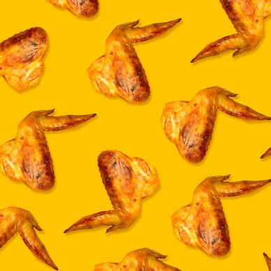 Pattern of cooked chicken wings on a yellow background.