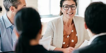 Smiling woman engaging in a meeting.