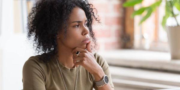 Woman looking thoughtfully to the side.
