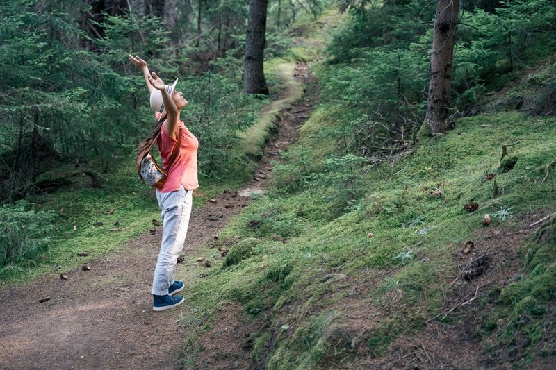 A Cheerful Adult tourist relaxing in the Nature. Casual Clothing.
