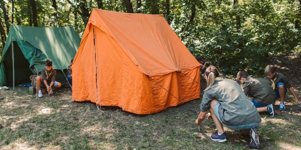 Woman enjoying a peaceful tent setup in nature.