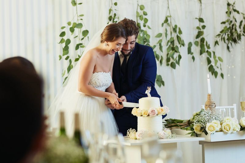 Shot of a middle aged couple cutting the cake at their wedding reception