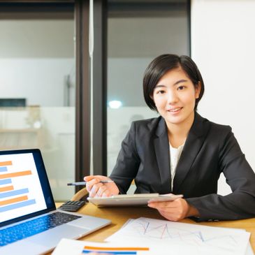 Businesswoman presenting data charts in a meeting room.