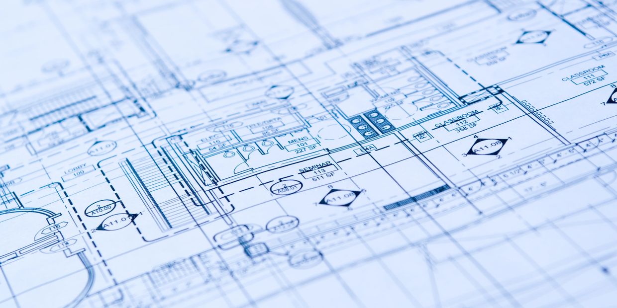 Close-up of a detailed architectural blueprint for a building layout.