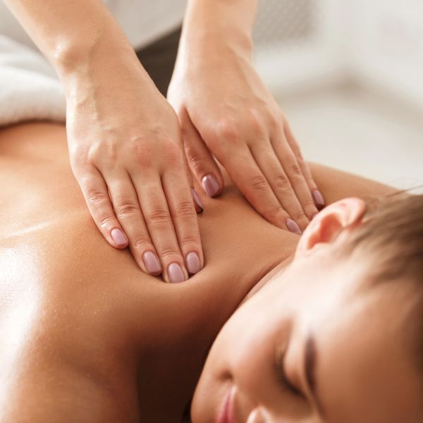 Hands giving a relaxing back massage.