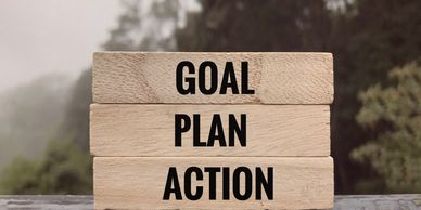 Blocks of wood with goal, plan, action