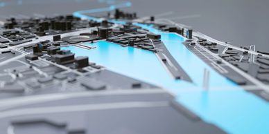 3D city model with highlighted blue waterways and black buildings.