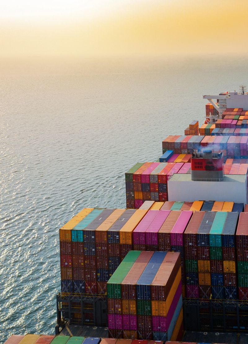top aerial view of the large volume of TEU containers on ship sailing in the sea carriage the shipment from loading port to destination,  heading to the destination of success light
