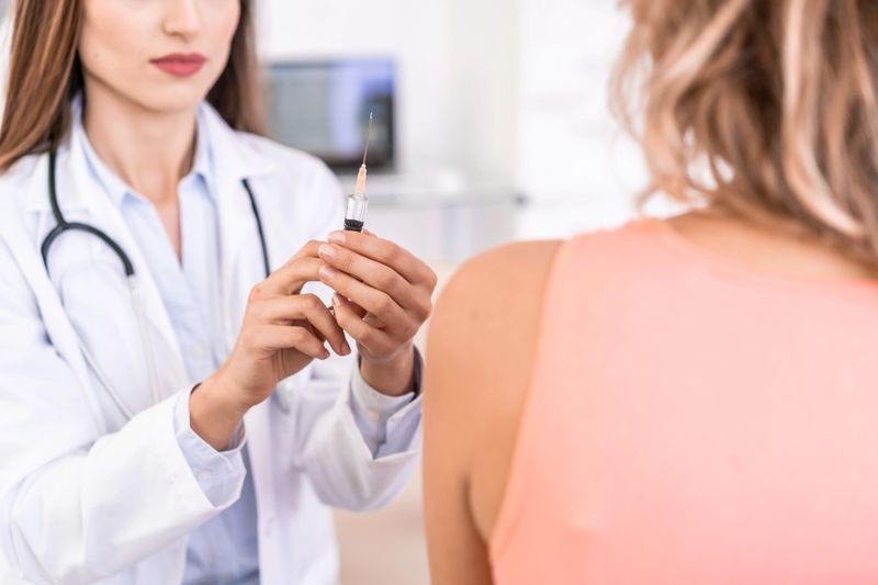 Female doctor administers the vaccine to a patient