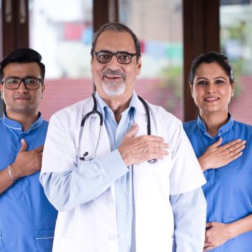 Doctors with hands on their chests showing respect and unity.