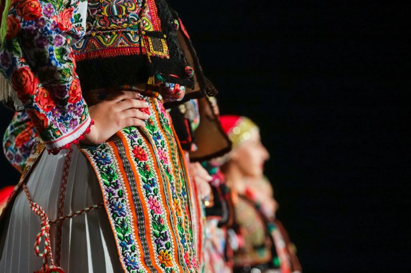 Close up on detail of young Romanian female dancer traditional folkloric costume. Folklore of Romania