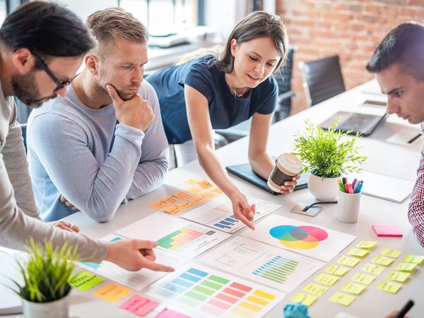 A group of people looking at a plan