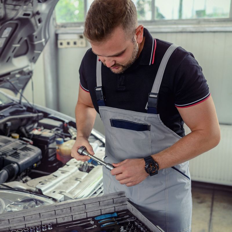 Auto mechanic working in garage. Repair service