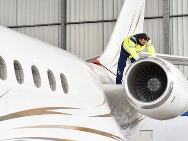 man checking a corporate jet engine 