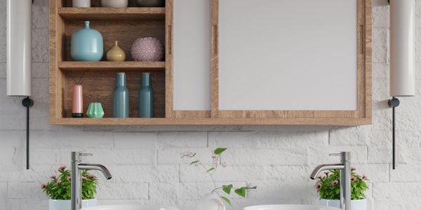Modern bathroom with double sinks, wooden cabinet, and decorative vases.