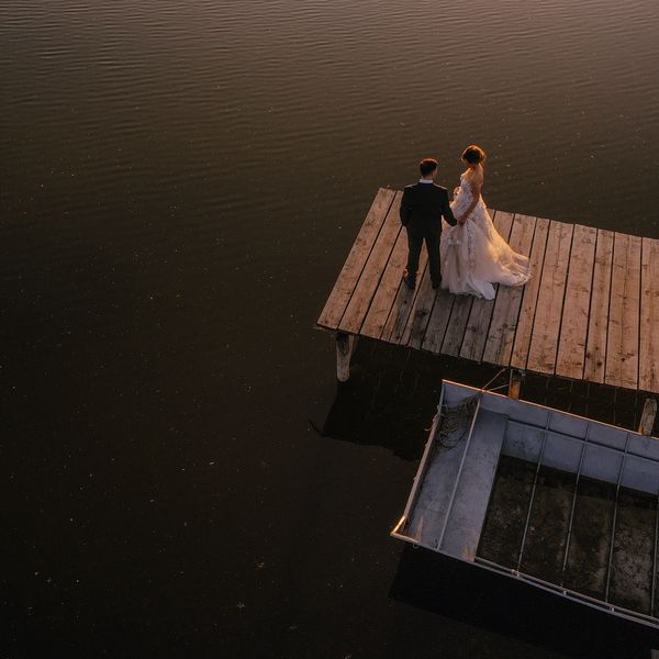 Aerial view of Bride and Groom at the end of a jetty