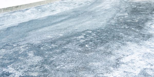 Icy road with patches of snow and ice.