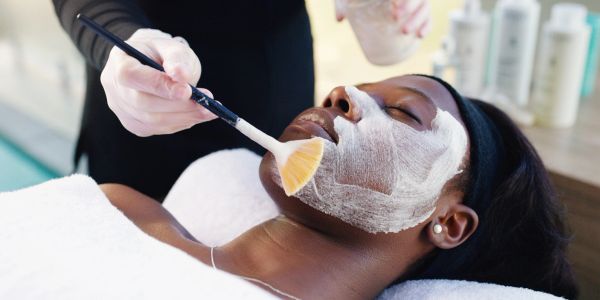 Woman receiving a facial treatment.