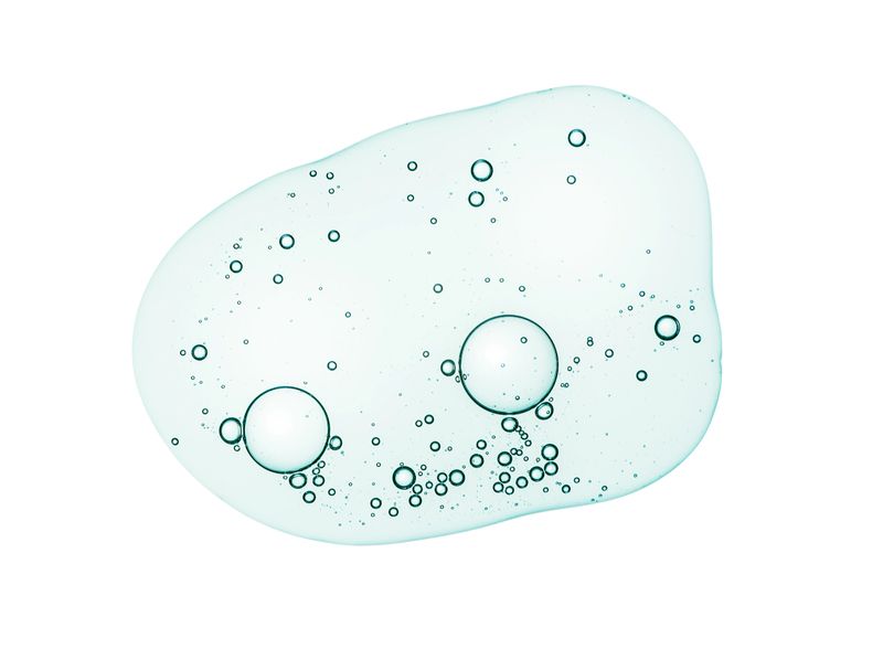 Liquid serum gel on a table screen of microscope white isolated background