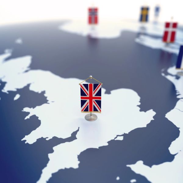 UK flag pinned on a map of the British Isles.
