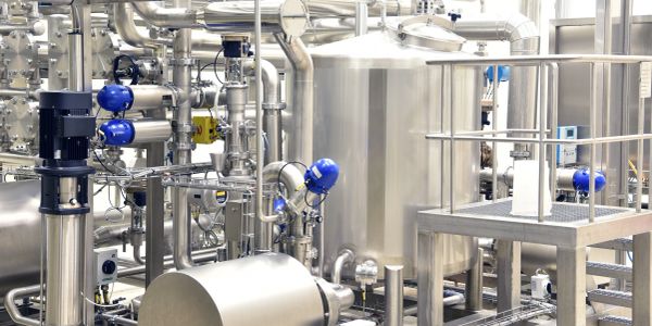 Equipos industriales de acero inoxidable en una planta de procesamiento.