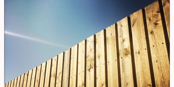 Durable and stylish wood fence installed by licensed and insured JB Unlimited Fencing, LLC, enhancing privacy and curb appeal for homes and businesses.”