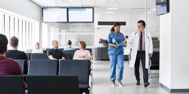 Doctors discussing patient files in a hospital waiting area.