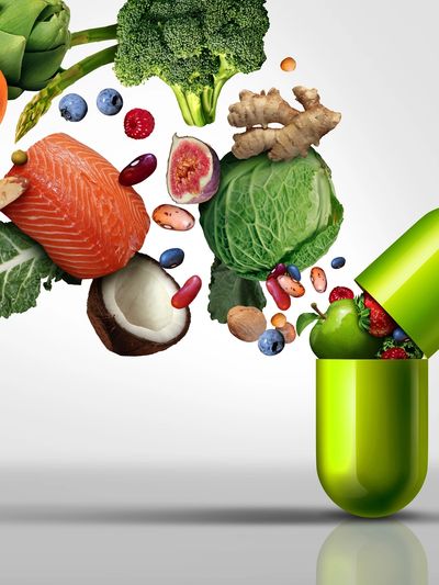 Green capsule filled with fresh fruits, vegetables, nuts, and fish.