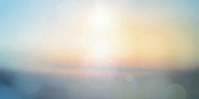 A soft, blurred sunrise or sunset with pastel colors and lens flare.