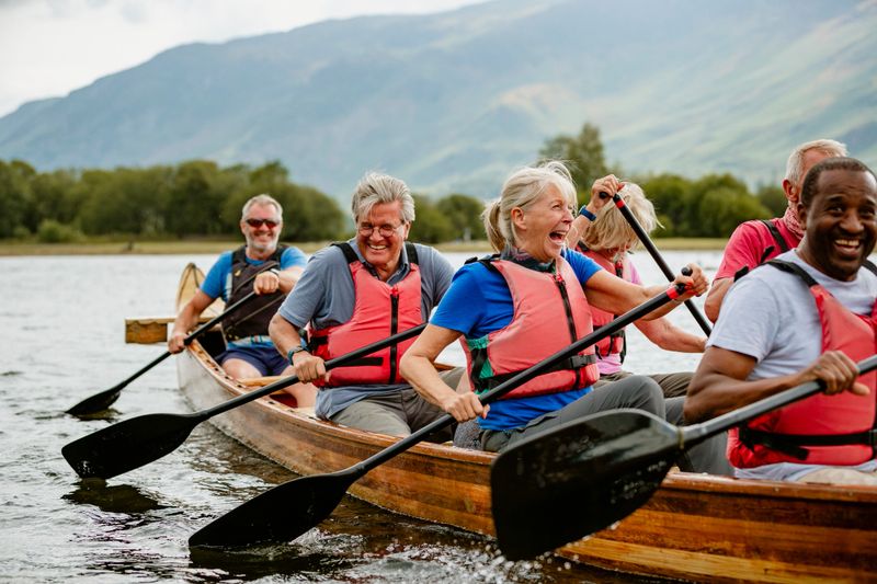 A senior group of friends enjoying rowing on the River Derwent