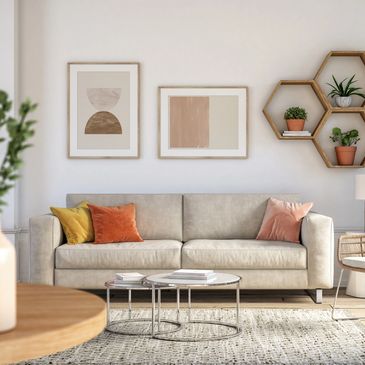 Modern living room with beige sofa, colorful pillows, and geometric wall art.