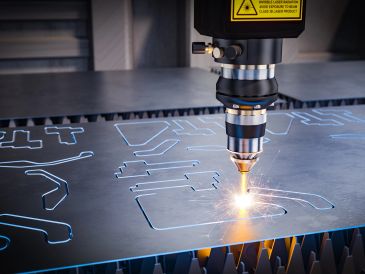 Laser cutting machine precisely cutting shapes from metal sheet.