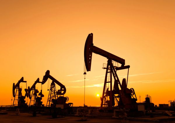 Oil pumpjacks operating at sunset.