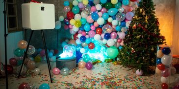 Photo booth setup with camera and backdrop in an indoor space.