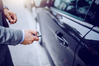 Man using programmed key fob to unlock vehicle