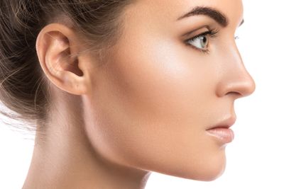 Side view of a woman that shows her eye and ear.